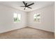 Bedroom featuring neutral carpet, ceiling fan, and two windows with natural light at 162 N Hunt W Dr, Mesa, AZ 85203