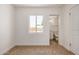 Bedroom featuring neutral carpet, a window for natural light, and an adjacent bathroom at 162 N Hunt W Dr, Mesa, AZ 85203