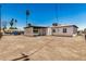 Exterior view of the home and a detached carport in a dirt lot backyard at 162 N Hunt W Dr, Mesa, AZ 85203