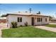 Well-maintained home with green lawn, white brick exterior, and a cozy covered porch at 162 N Hunt W Dr, Mesa, AZ 85203