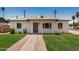 Charming single-story home with a well-manicured lawn and inviting front entrance at 162 N Hunt W Dr, Mesa, AZ 85203