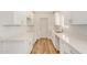 Stylish kitchen featuring new white cabinets, quartz countertops, and modern hardware at 162 N Hunt W Dr, Mesa, AZ 85203