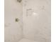 Close-up of newly remodeled marble shower with a soap inset and rain shower head at 162 N Hunt W Dr, Mesa, AZ 85203