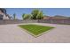 Spacious backyard featuring artificial turf, gravel landscaping, and a secure block fence at 1671 E Silktassel Trl, San Tan Valley, AZ 85143