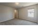 Comfortable bedroom featuring neutral carpet and a window for natural lighting at 1671 E Silktassel Trl, San Tan Valley, AZ 85143