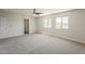 Light-filled bedroom featuring neutral carpet and windows for natural lighting at 1671 E Silktassel Trl, San Tan Valley, AZ 85143