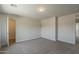 Spacious bedroom with neutral carpet, overhead lighting, and a door leading to a closet at 1671 E Silktassel Trl, San Tan Valley, AZ 85143