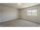 Bright bedroom with neutral carpet and a window providing natural light at 1671 E Silktassel Trl, San Tan Valley, AZ 85143