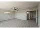 Large bedroom with ceiling fan, neutral carpet, and sliding door closet with open doorway at 1671 E Silktassel Trl, San Tan Valley, AZ 85143