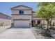 Charming two-story home featuring an attached two-car garage and landscaped front yard at 1671 E Silktassel Trl, San Tan Valley, AZ 85143