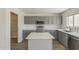 Well-equipped kitchen featuring gray cabinets, stainless appliances, and an island with white top at 1671 E Silktassel Trl, San Tan Valley, AZ 85143