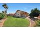 Landscaped backyard showcases a lush lawn, mature trees, and an inviting covered patio at 19007 N 79Th Dr, Glendale, AZ 85308