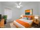 Staged bedroom features natural light, soft rug, updated furniture, and a ceiling fan at 19007 N 79Th Dr, Glendale, AZ 85308