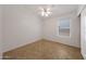 The interior showcases a tidy, neutral bedroom with tile flooring and a ceiling fan at 19007 N 79Th Dr, Glendale, AZ 85308