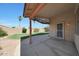 Covered patio, designed for relaxation, overlooks a well-maintained lawn with a secure fence at 19007 N 79Th Dr, Glendale, AZ 85308