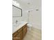 Well-lit bathroom featuring a wooden vanity, a white toilet, and a shower/tub combo at 2011 W Burgess Ln, Phoenix, AZ 85041