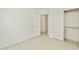 Minimalist bedroom with wood floors, access to another room, and a closet at 2011 W Burgess Ln, Phoenix, AZ 85041