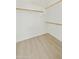 Bright walk-in closet with neutral walls, wood floors, and wood rods at 2011 W Burgess Ln, Phoenix, AZ 85041