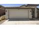 Attached two-car garage with traditional paneled doors and exterior lighting at 2011 W Burgess Ln, Phoenix, AZ 85041