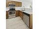 Modern kitchen features stainless steel appliances, bright countertop, and wood cabinets at 2011 W Burgess Ln, Phoenix, AZ 85041