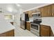 Bright kitchen features stainless steel appliances and white countertops at 2011 W Burgess Ln, Phoenix, AZ 85041