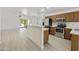 Bright, open kitchen with stainless steel appliances and a breakfast bar at 2011 W Burgess Ln, Phoenix, AZ 85041