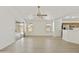 Open-concept living room boasts new floors, light, and access to patio at 2011 W Burgess Ln, Phoenix, AZ 85041