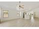 Spacious living room with windows, ceiling fan, and views of kitchen at 2011 W Burgess Ln, Phoenix, AZ 85041