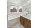Stylish main bathroom features a soaking tub, walk-in shower, and spacious vanity for a serene experience at 2011 W Burgess Ln, Phoenix, AZ 85041