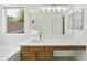 Main bathroom boasts double sinks, quartz countertops, and a walk-in shower, providing a spa-like retreat at 2011 W Burgess Ln, Phoenix, AZ 85041