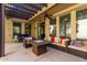 Cozy covered patio with comfortable seating and a fire pit table at 21014 W Ridge Rd, Buckeye, AZ 85396