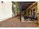 Backyard featuring a covered patio, gravel landscaping and mature trees at 21014 W Ridge Rd, Buckeye, AZ 85396