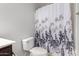 Cozy bathroom with a decorative shower curtain and matching floral accents at 21014 W Ridge Rd, Buckeye, AZ 85396