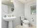 Bathroom with a pedestal sink, modern toilet, and neutral tile flooring at 21014 W Ridge Rd, Buckeye, AZ 85396