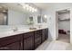 Bathroom features a double sink vanity, large mirror, and a walk-in closet at 21014 W Ridge Rd, Buckeye, AZ 85396