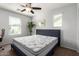 Bright bedroom with a ceiling fan, carpeted floors, and an adjacent study area at 21014 W Ridge Rd, Buckeye, AZ 85396