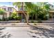 Inviting two-story home featuring a quaint front porch, mature trees, and well-maintained landscaping at 21014 W Ridge Rd, Buckeye, AZ 85396