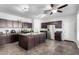 Spacious kitchen features dark wood cabinets, stainless steel appliances and a large granite island at 21014 W Ridge Rd, Buckeye, AZ 85396