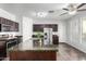 Stylish kitchen showcasing dark wood cabinetry, granite counters, and a large center island with a sink at 21014 W Ridge Rd, Buckeye, AZ 85396