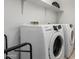 Modern laundry room featuring a Samsung washer and dryer set at 21014 W Ridge Rd, Buckeye, AZ 85396