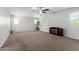 This expansive living room offers neutral walls, plush carpeting, and a decorative fireplace at 21014 W Ridge Rd, Buckeye, AZ 85396