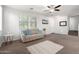 Cozy living room features neutral furniture, soft lighting, and neutral carpet at 21014 W Ridge Rd, Buckeye, AZ 85396