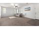Bright living room featuring neutral colored walls, carpet, and a comfortable couch with blue pillows at 21014 W Ridge Rd, Buckeye, AZ 85396