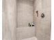 Tiled walk-in shower featuring a built-in bench and recessed shelving at 21014 W Ridge Rd, Buckeye, AZ 85396