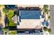 Aerial view of a home with a gray roof, lush backyard with artificial grass, pool, and patio area at 21022 E Arroyo Verde Ct, Queen Creek, AZ 85142