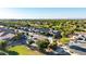 Aerial shot of a neighborhood with mature trees, green spaces, and well-manicured lawns on a sunny day at 21022 E Arroyo Verde Ct, Queen Creek, AZ 85142
