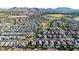 Expansive aerial view of a residential area with mountain views, featuring well-maintained homes and landscaping at 21022 E Arroyo Verde Ct, Queen Creek, AZ 85142