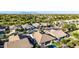 Aerial view of a residential area highlighting homes with pools, well-kept lawns, and mature landscaping at 21022 E Arroyo Verde Ct, Queen Creek, AZ 85142