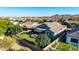 Lush backyard oasis featuring a manicured lawn, covered patio, and mountain views at 21022 E Arroyo Verde Ct, Queen Creek, AZ 85142