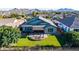 Private backyard with artificial turf, a covered patio area, and a cozy fire pit for outdoor entertainment at 21022 E Arroyo Verde Ct, Queen Creek, AZ 85142